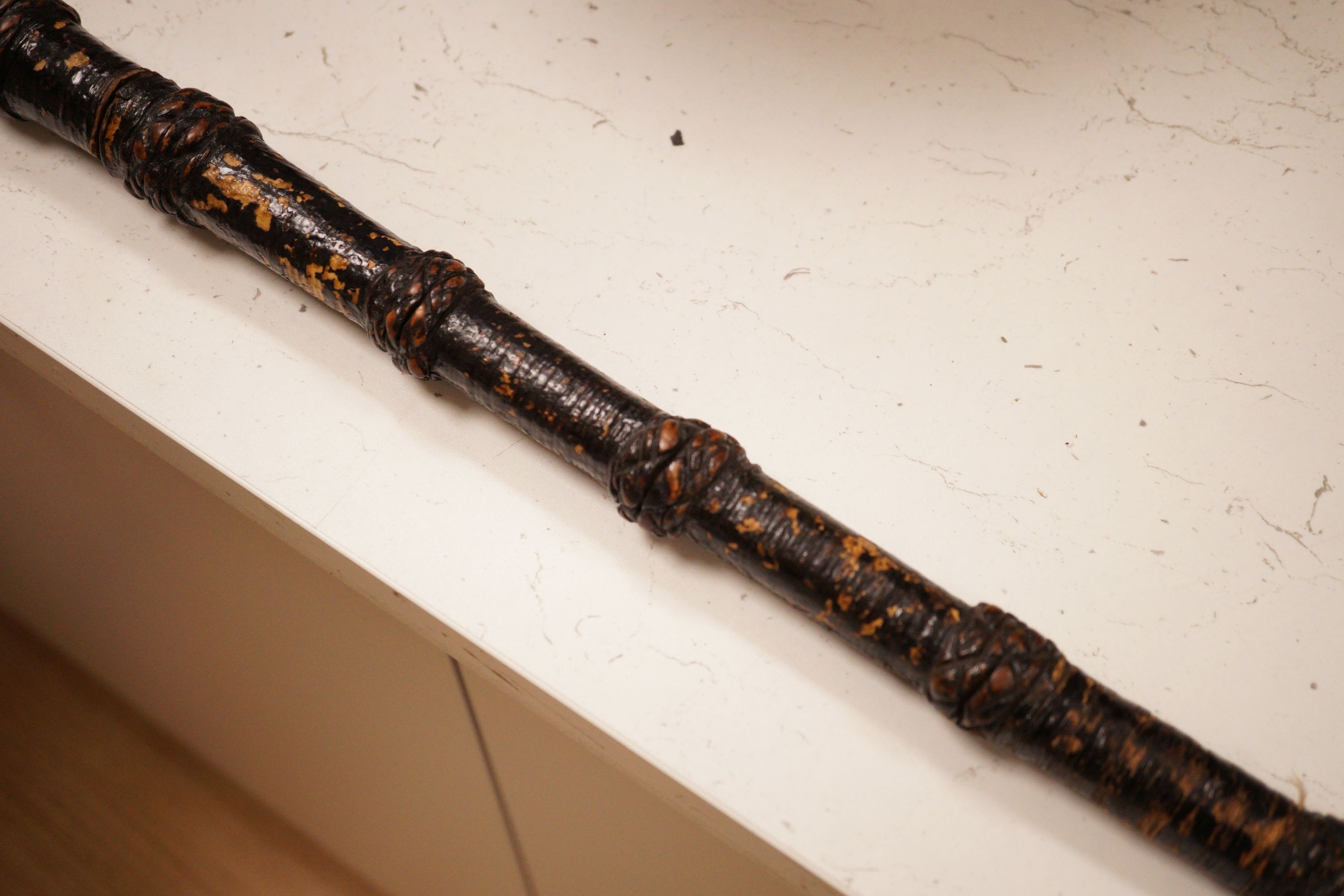 A ceremonial sword stick with removable brush end